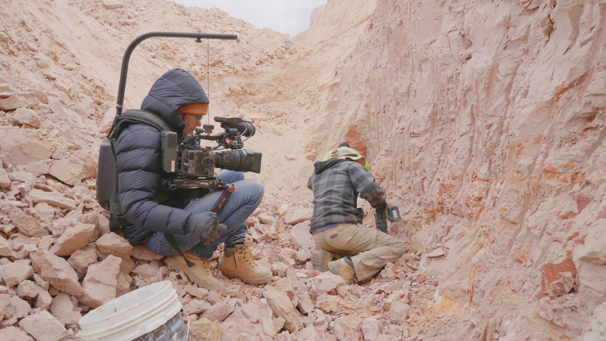 Olivia filming in a rocky outback quarry
