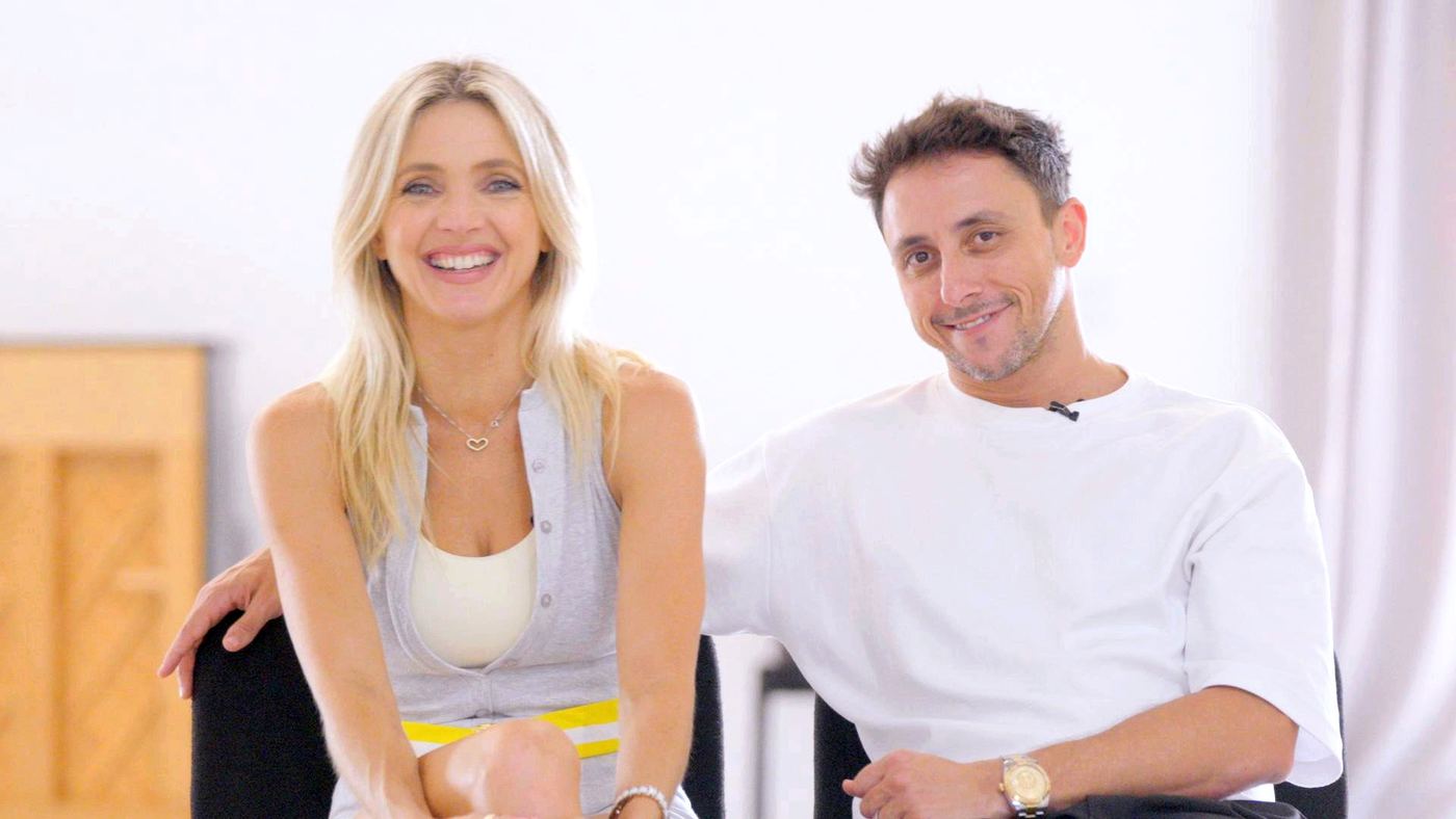 Two presenters smiling on a bright set