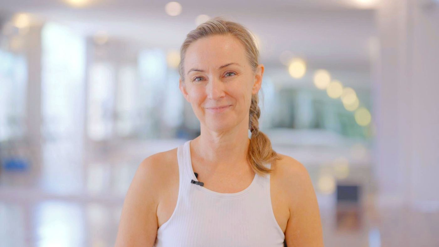 A woman in a white top in a soft, bright interior