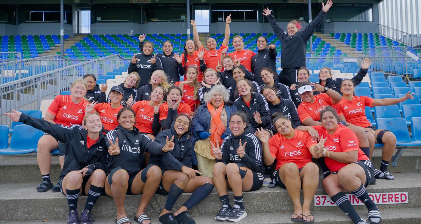 A women's football team celebrating in a stadium