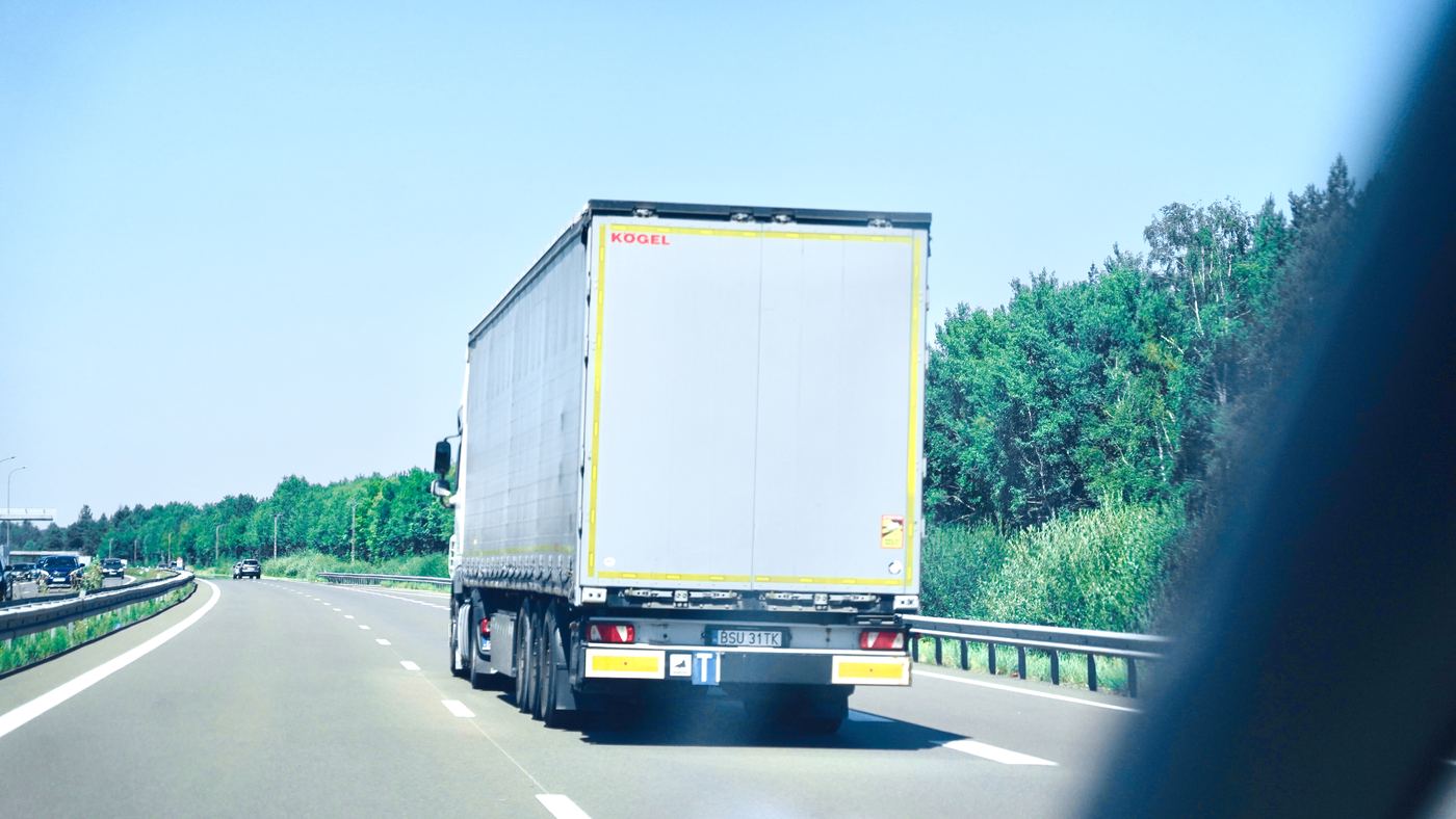 A truck on a motorway seen from a car window