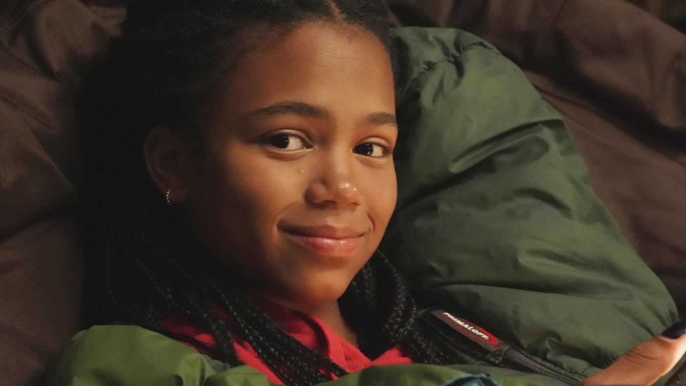 A girl smiling, lying on a pillow